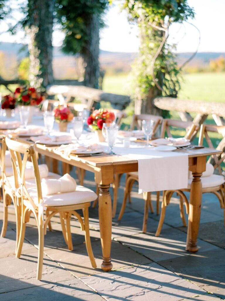 Wooden reception table on the patio at a Lion Rock Farm wedding.