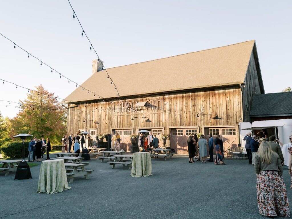 People outside the barn venue of the Lion Rock Farm wedding location.